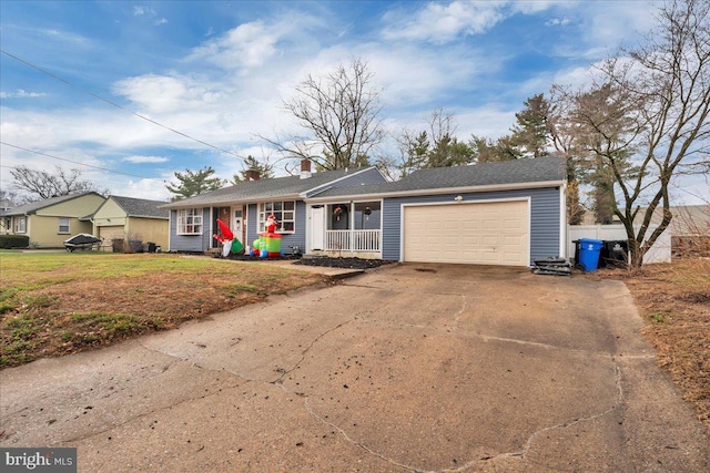 ranch-style home with covered porch, a front yard, and a garage