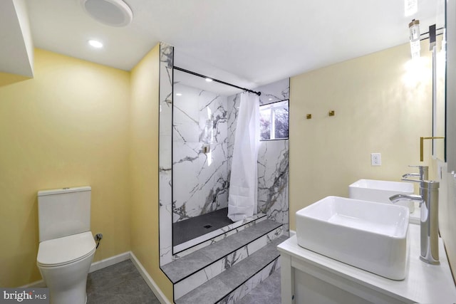 bathroom with tile patterned floors, curtained shower, vanity, and toilet