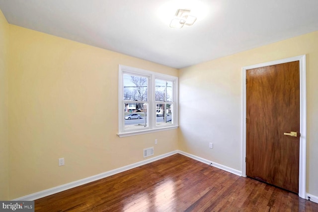 empty room with dark hardwood / wood-style floors