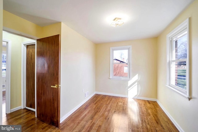 spare room with hardwood / wood-style floors