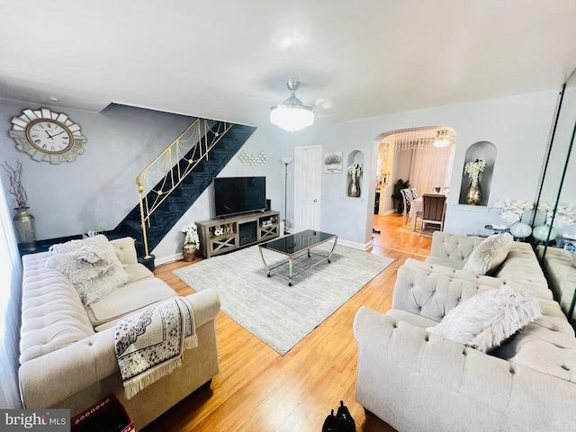 living room with wood-type flooring and ceiling fan