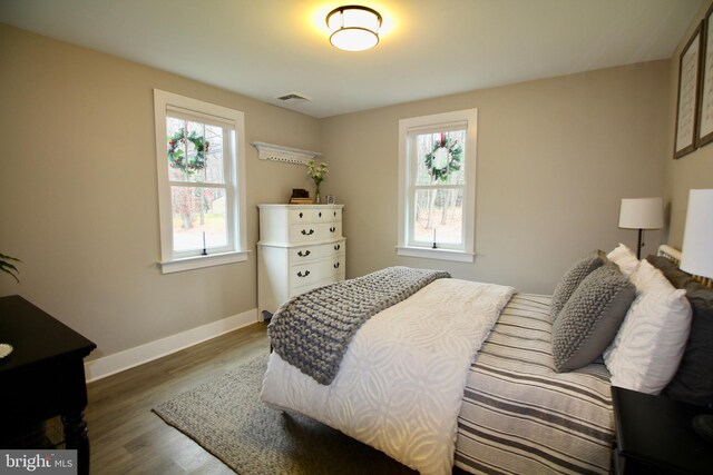 bedroom with dark wood-type flooring