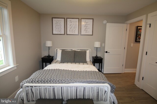 bedroom featuring dark hardwood / wood-style flooring