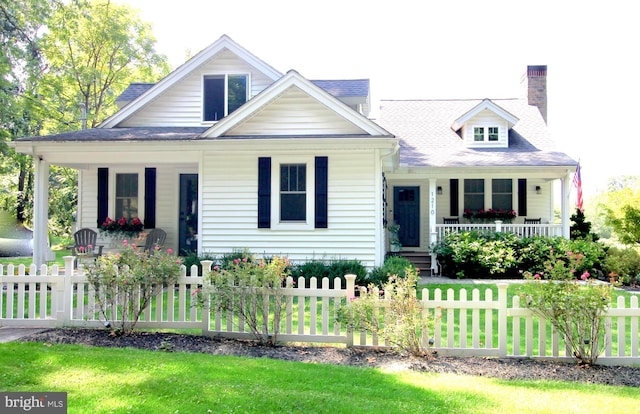 view of front of property with covered porch and a front yard