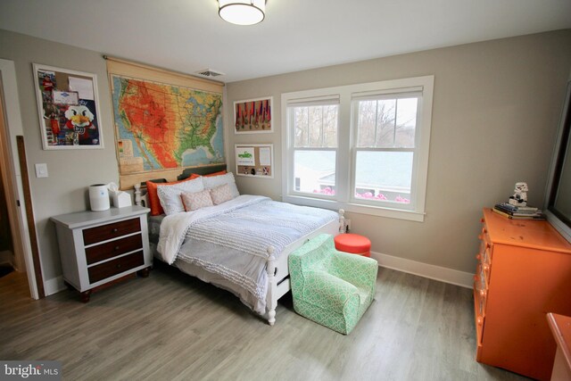 bedroom with wood-type flooring