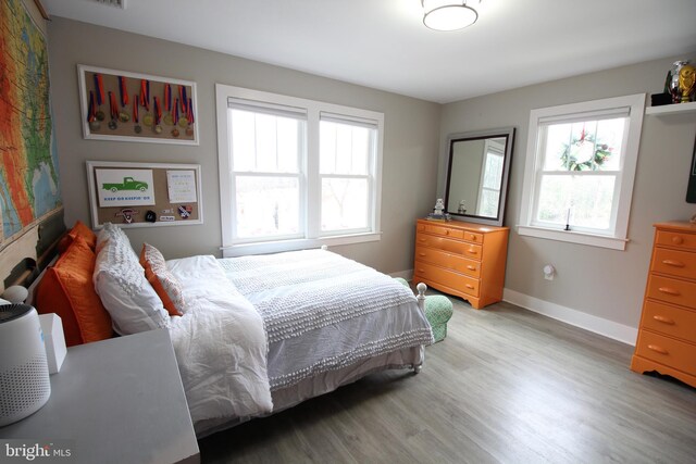 bedroom with wood-type flooring