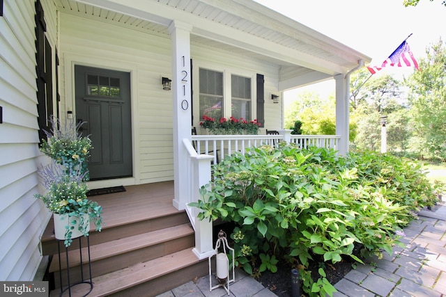 view of exterior entry with a porch