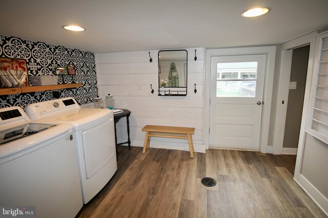 laundry area featuring hardwood / wood-style floors and washing machine and dryer