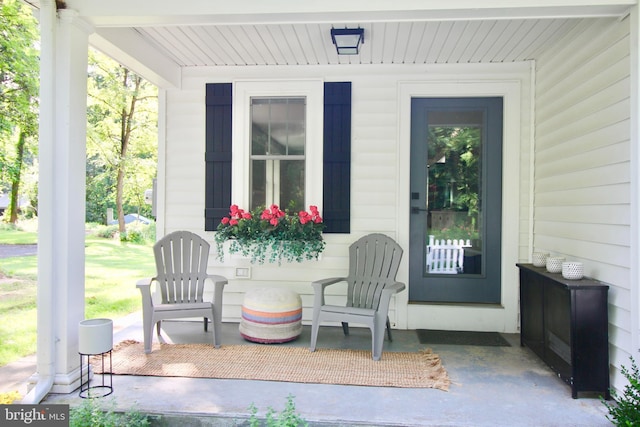 view of exterior entry featuring covered porch