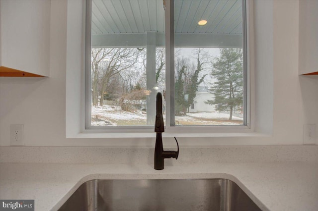 details featuring sink and light stone counters