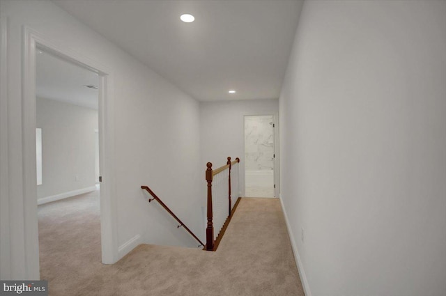 hallway featuring light carpet