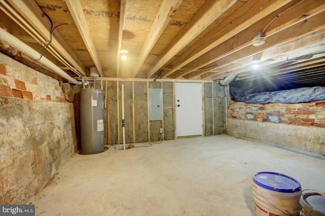 basement featuring electric panel and water heater