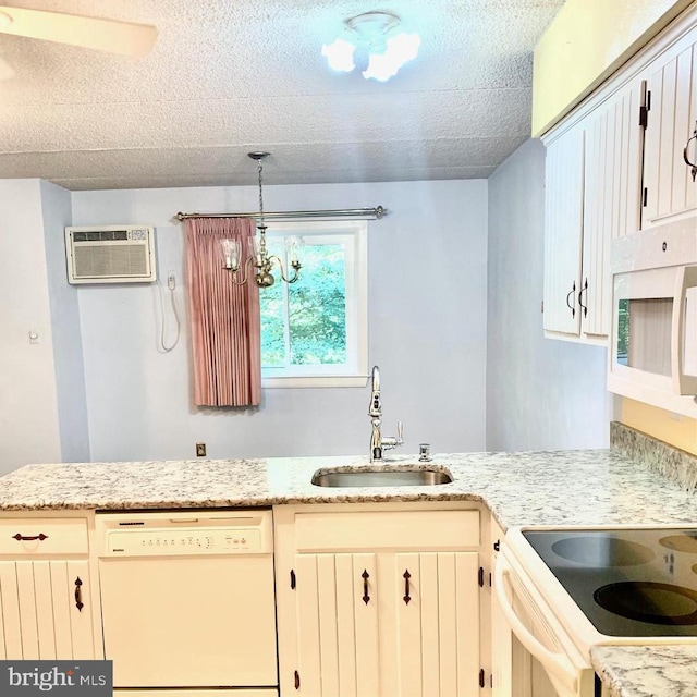 kitchen featuring white cabinetry, sink, a notable chandelier, decorative light fixtures, and white appliances