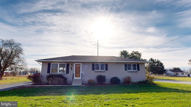 ranch-style home featuring a front yard