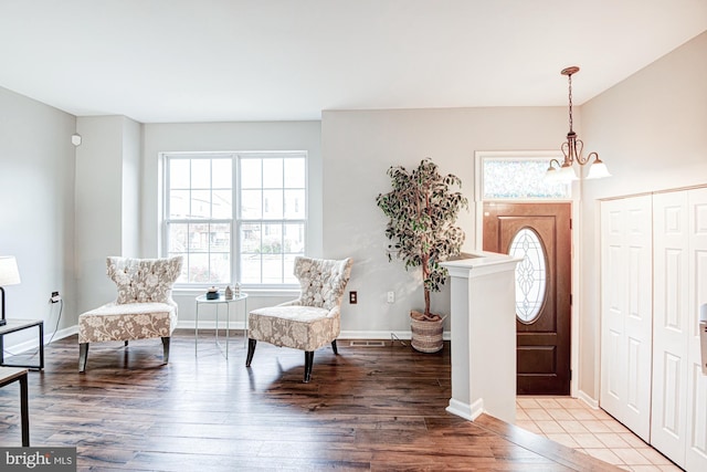 foyer entrance featuring hardwood / wood-style flooring and a chandelier