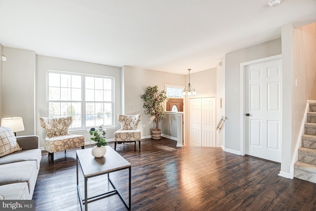 living room featuring dark hardwood / wood-style floors and a notable chandelier