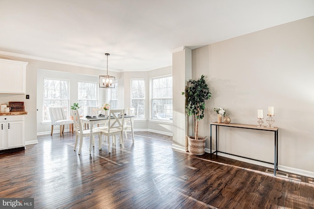 dining space featuring dark hardwood / wood-style floors, a healthy amount of sunlight, and crown molding