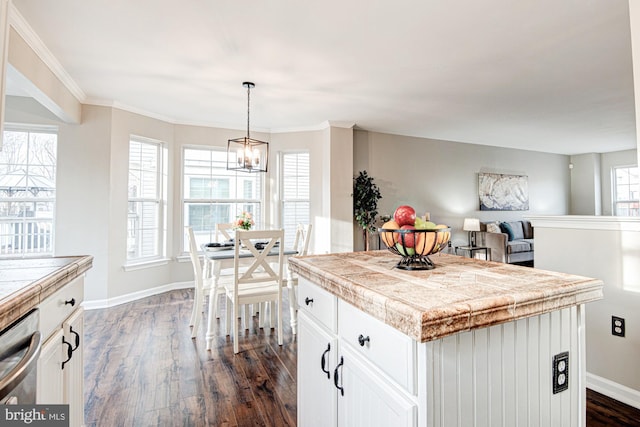 kitchen featuring white cabinetry, a kitchen island, dark wood-type flooring, and stainless steel dishwasher