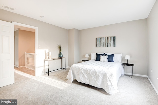 bedroom featuring light carpet