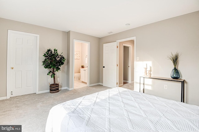 carpeted bedroom featuring ensuite bathroom