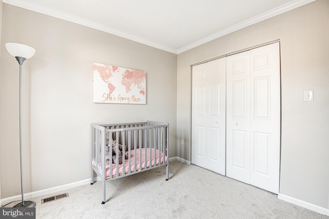 carpeted bedroom with a closet, a nursery area, and ornamental molding