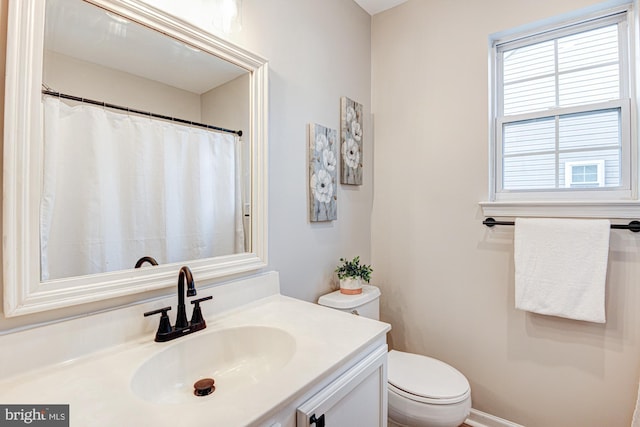 bathroom featuring vanity and toilet