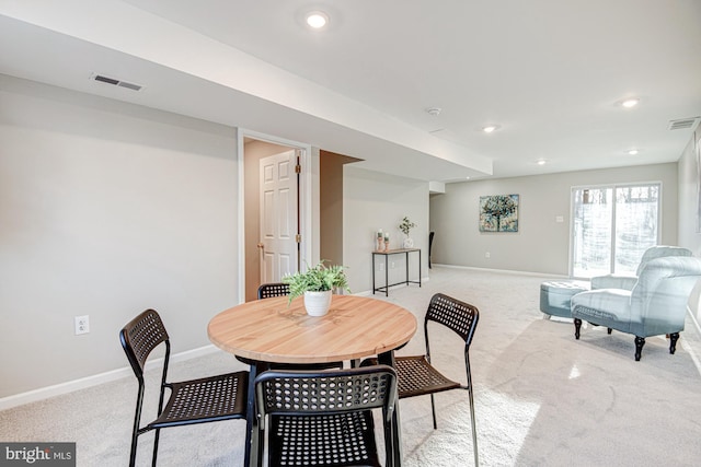 dining room featuring light colored carpet