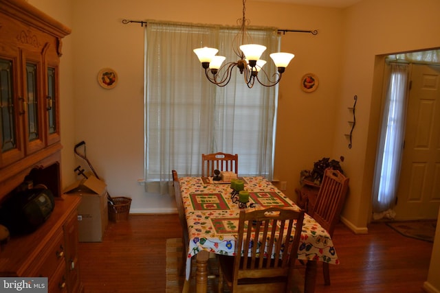 dining room with a chandelier and dark hardwood / wood-style floors