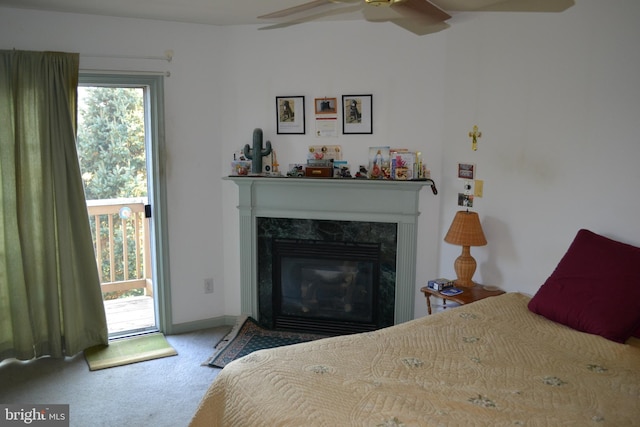 bedroom with carpet, ceiling fan, and a high end fireplace