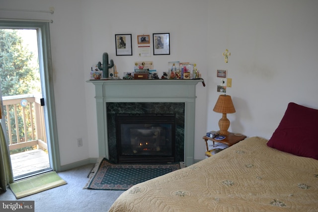 bedroom with carpet flooring and a fireplace