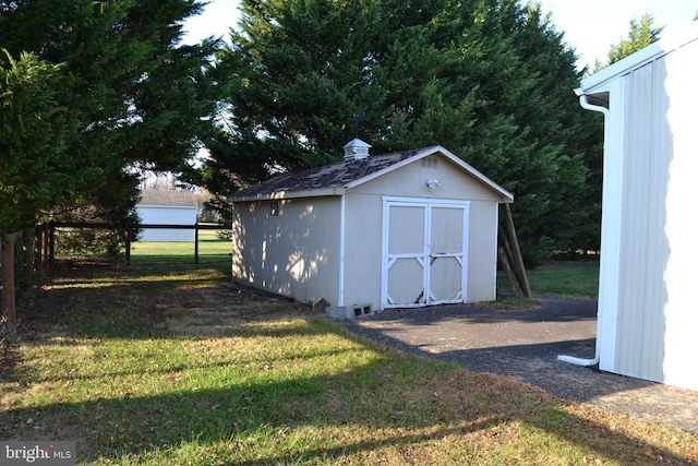 view of outdoor structure featuring a lawn