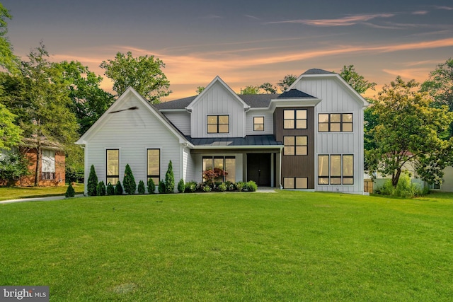 modern farmhouse with a lawn