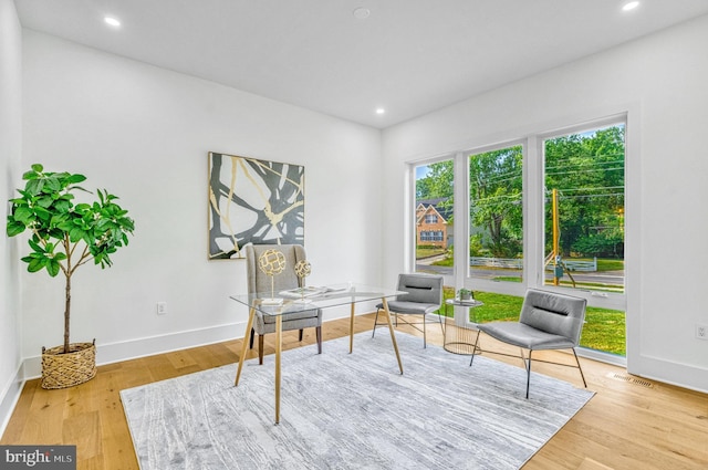 home office with light hardwood / wood-style flooring