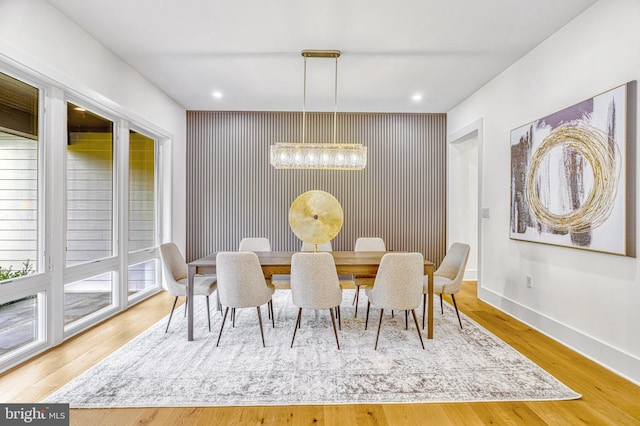 dining room with an inviting chandelier and light hardwood / wood-style flooring