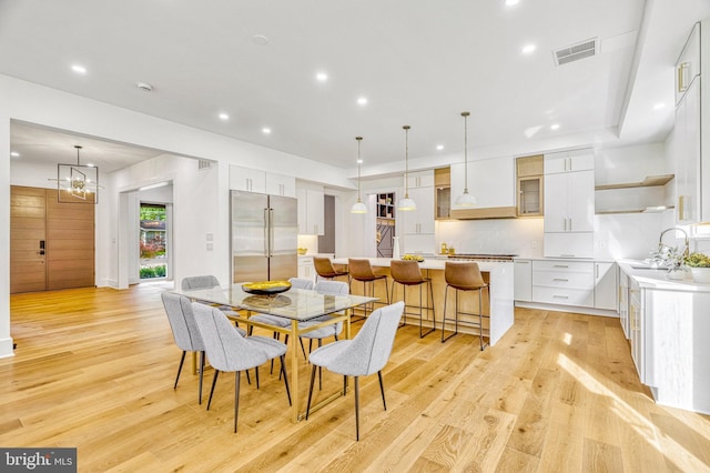 dining room with sink and light hardwood / wood-style floors