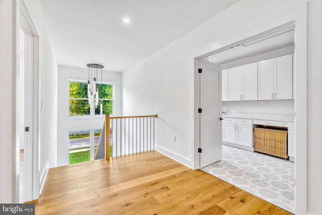 hall with light hardwood / wood-style flooring