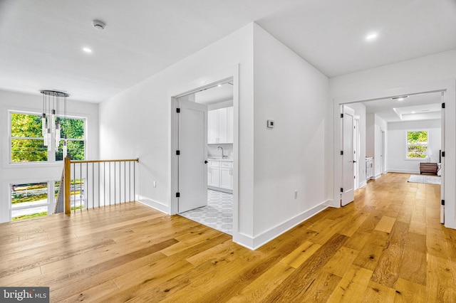 hallway featuring light hardwood / wood-style flooring and sink