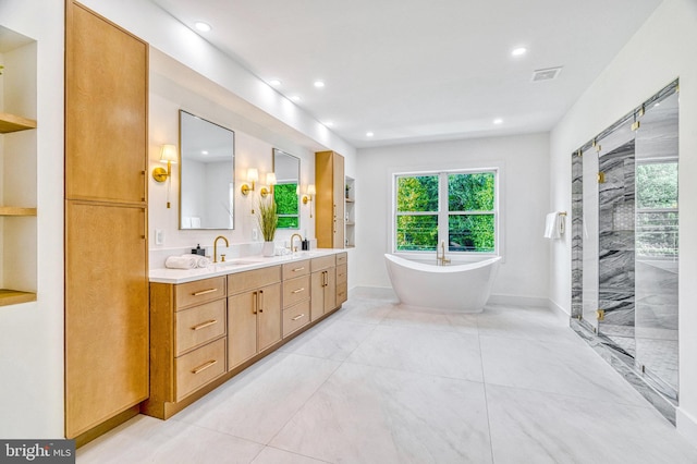 bathroom featuring vanity and independent shower and bath