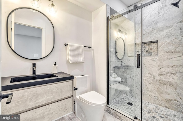 bathroom featuring vanity, toilet, and a shower with door