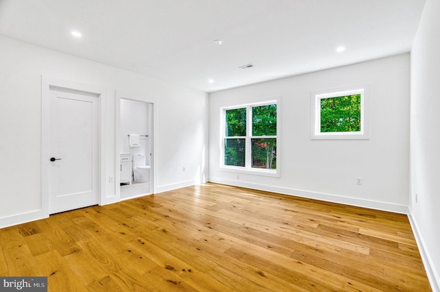 spare room with light hardwood / wood-style flooring