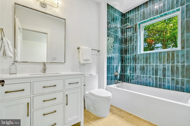 full bathroom featuring toilet, vanity, tile patterned floors, and tiled shower / bath