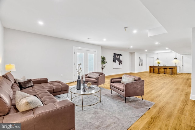 living room with french doors and light hardwood / wood-style flooring