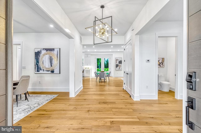 entrance foyer with a chandelier and light hardwood / wood-style floors