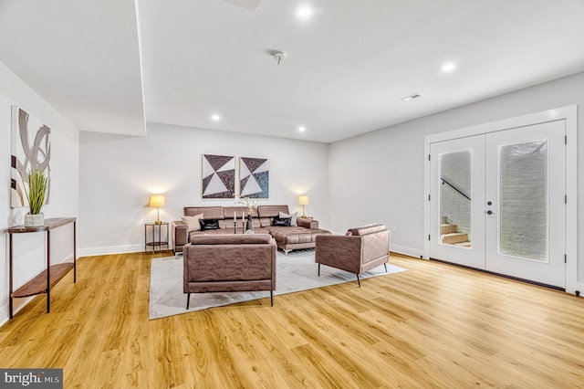 living room featuring french doors and light hardwood / wood-style floors