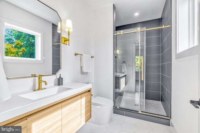 bathroom with tile patterned floors, vanity, toilet, and a shower with shower door