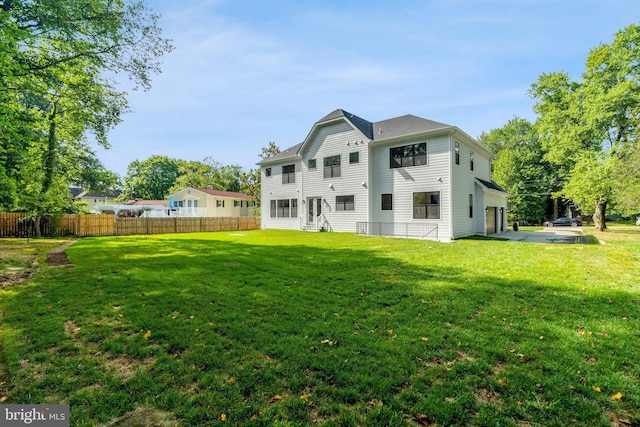 rear view of house featuring a yard