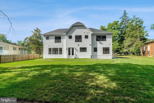 back of house with a lawn