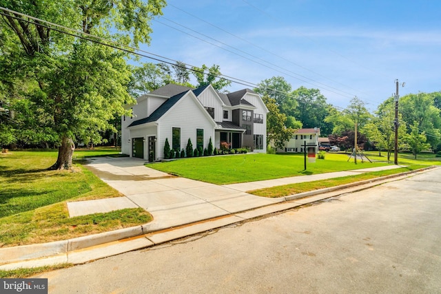 view of property featuring a garage and a front yard