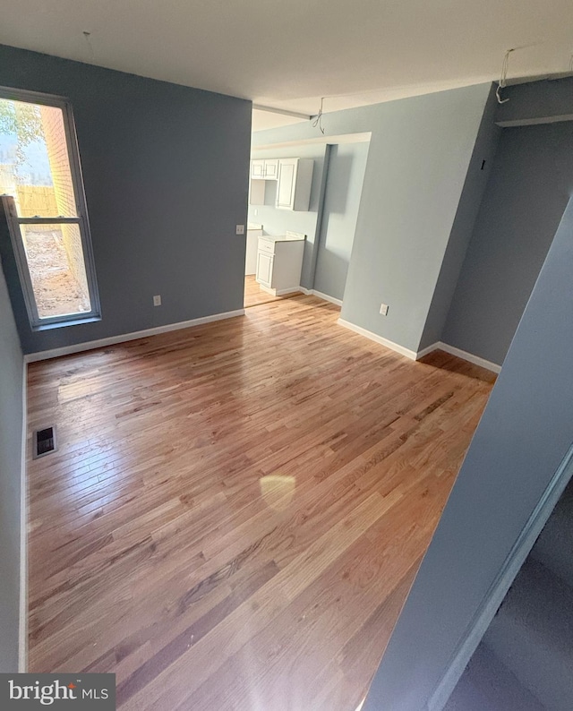 1103 N Carrollton Ave, Baltimore, MD 21217 - empty room featuring light wood-type flooring and baseboards