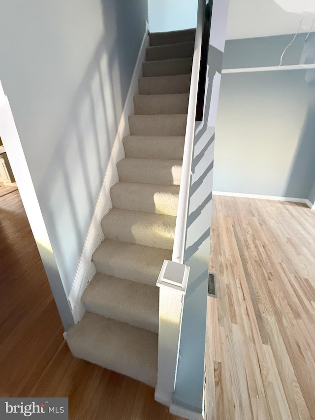 stairway featuring hardwood / wood-style floors